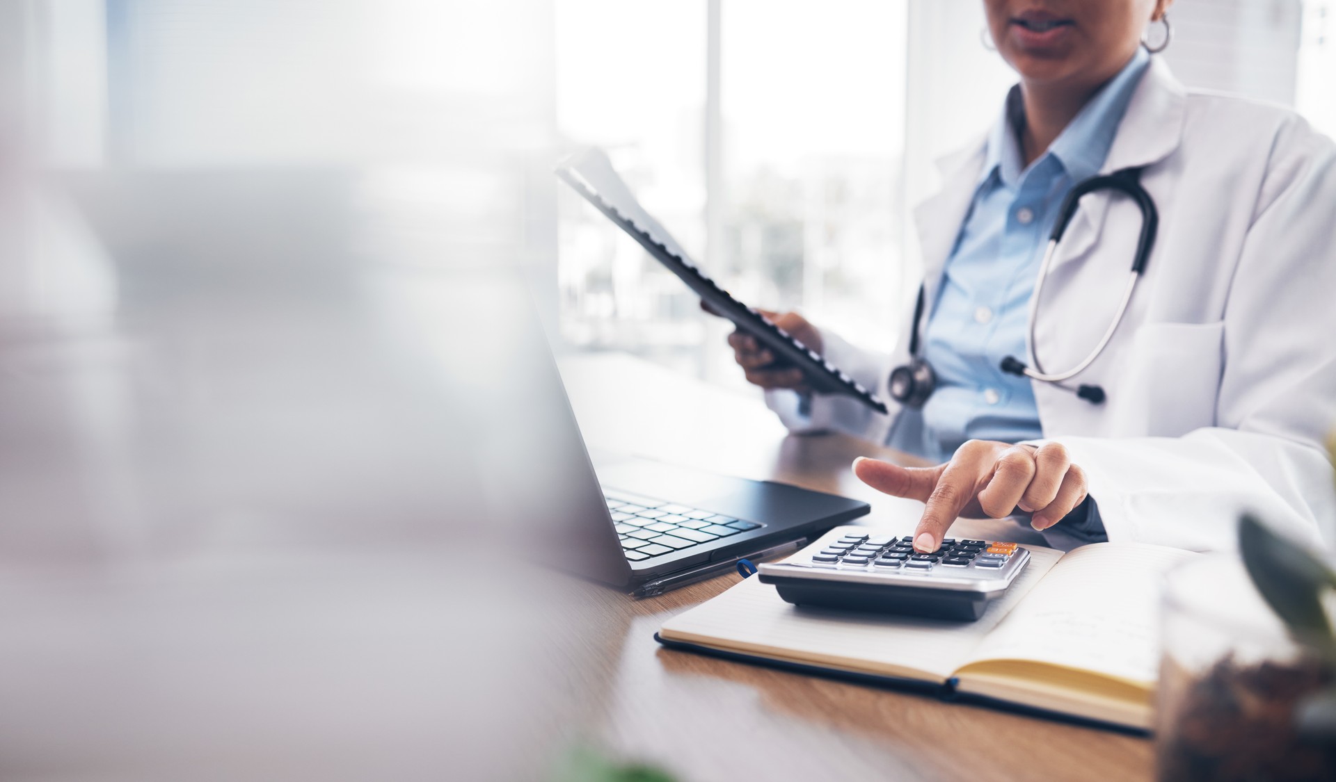 Accounting doctor, calculator and hands of person calculating bookkeeping finance, hospital budget or medical savings. Mockup space, healthcare and accountant working on taxes, audit or compliance