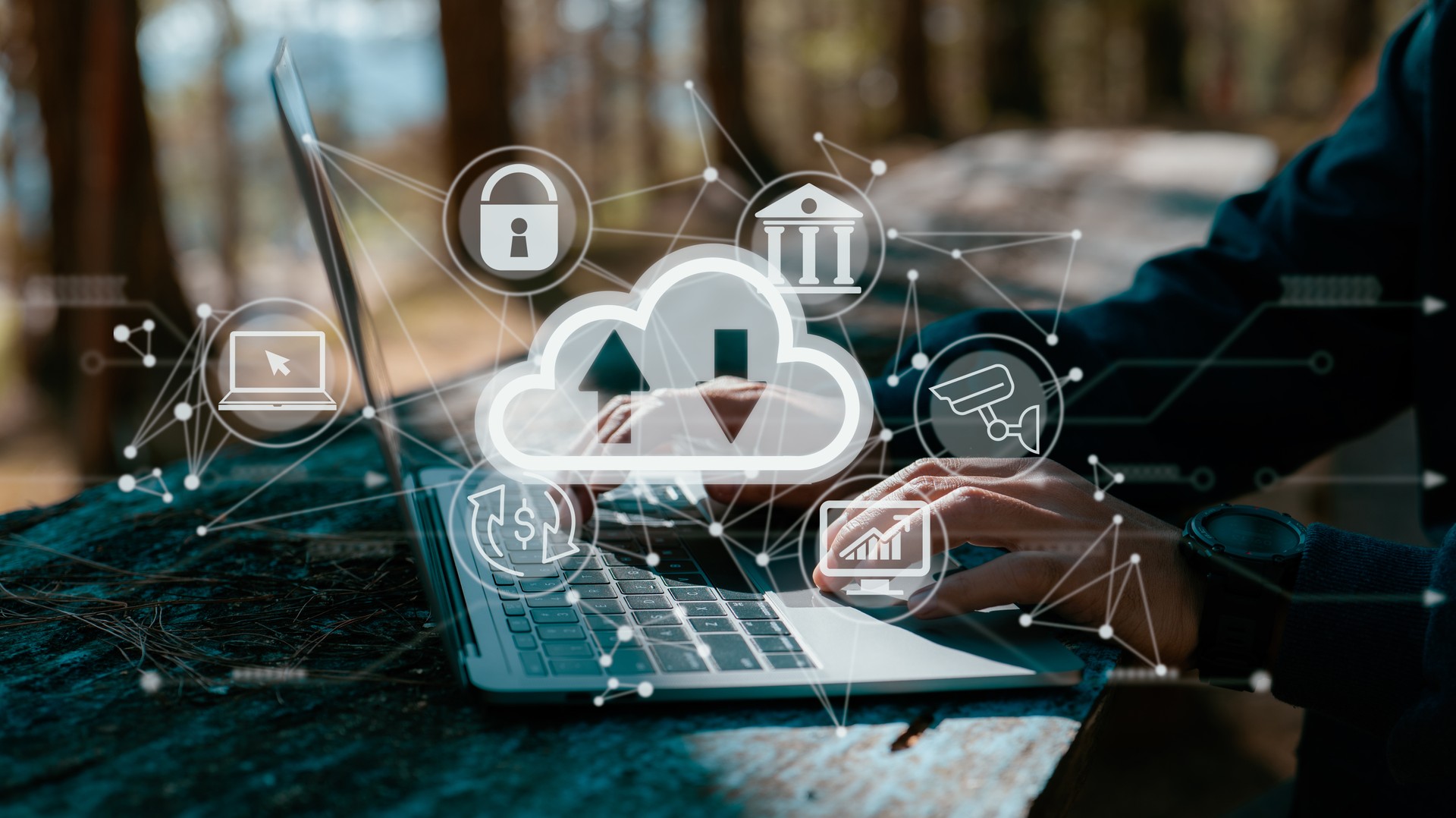 A guy works on a laptop while holding a cloud computing diagram. Data storage, networking, and internet service principles are all based on cloud technology.